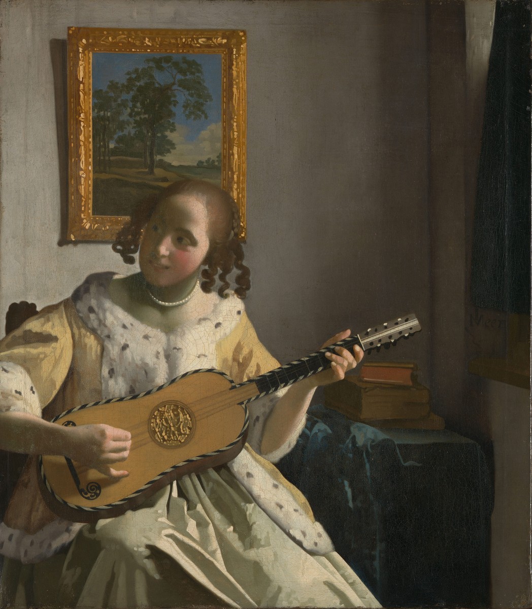 Youg woman playing a guitar by Johannes Vermeer