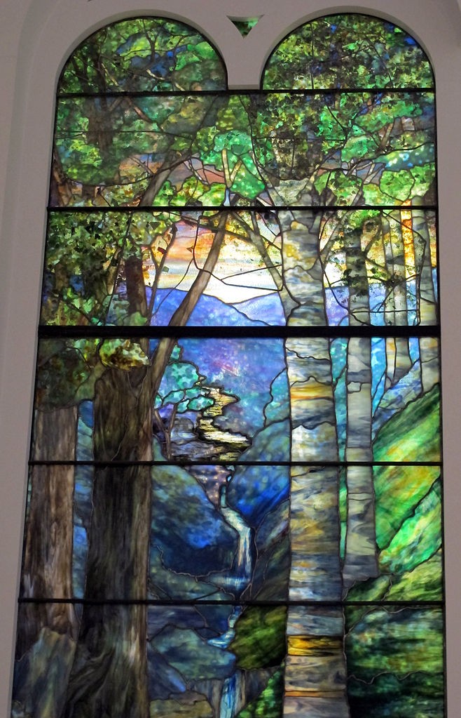 Window with sunrise in the forest in spring by Louis Comfort Tiffany